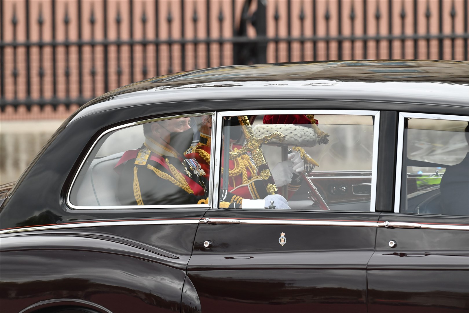 The Sword of State, left, leaves Buckingham Palace for the state opening of Parliament in 2021 (PA)