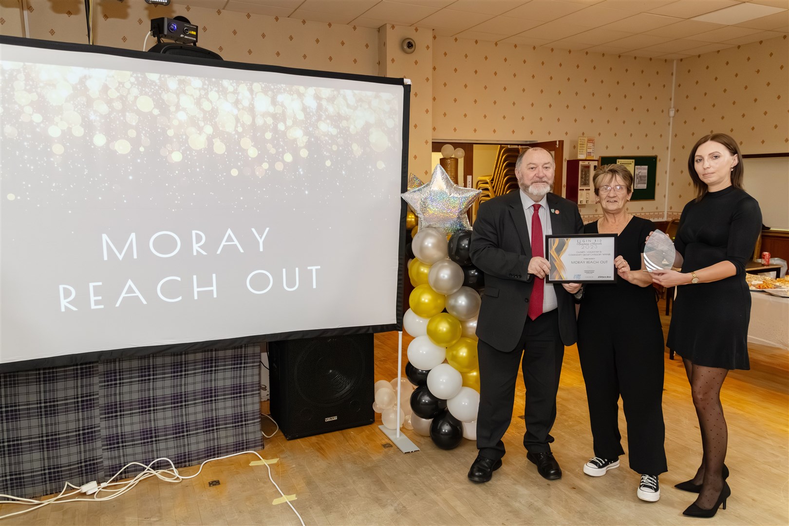 John Divers presenting the charity, voluntary and community Group award to Mo Wishart and Anna Bebas from Moray Reach Out. Picture: Beth Taylor.