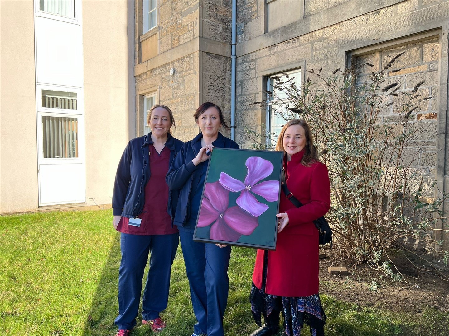 Mental health nurses Corrine Lackie and Fiona Burns with Elgin artist Ruth Asiabani and her painting at Dr Gray’s Hospital.
