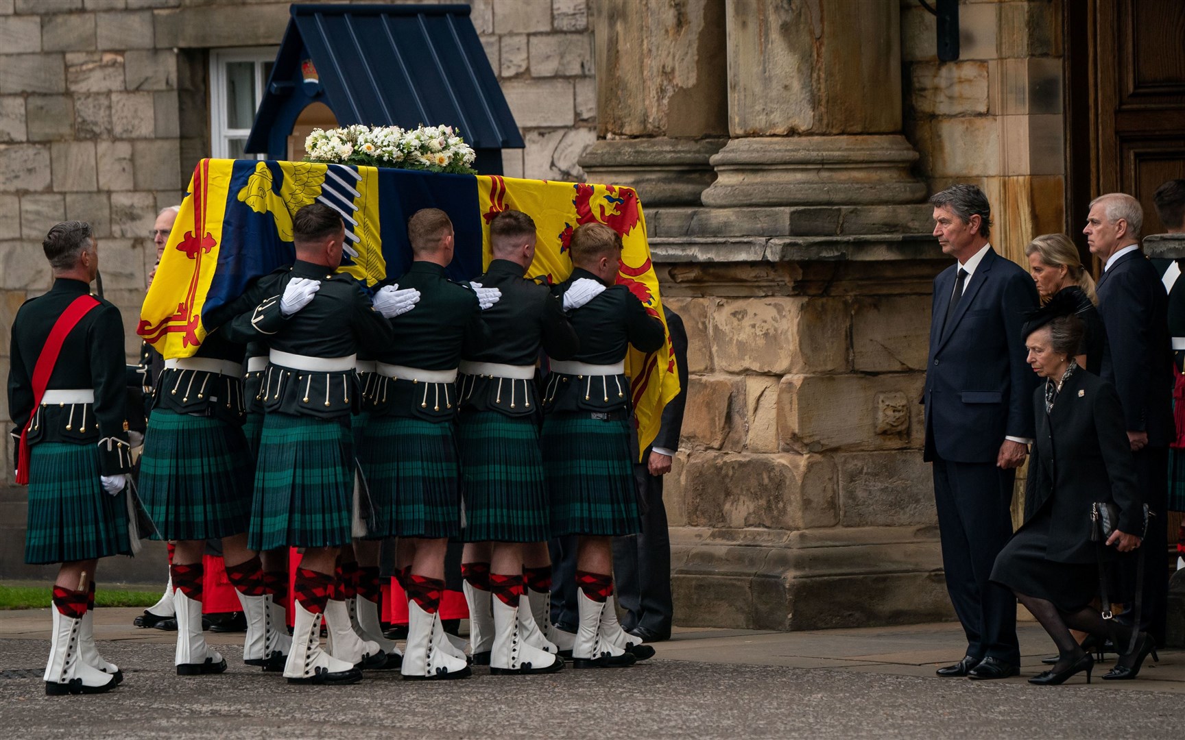 The Princess Royal curtseys as her mother’s coffin is carried into the palace (Aaron Chown/PA)