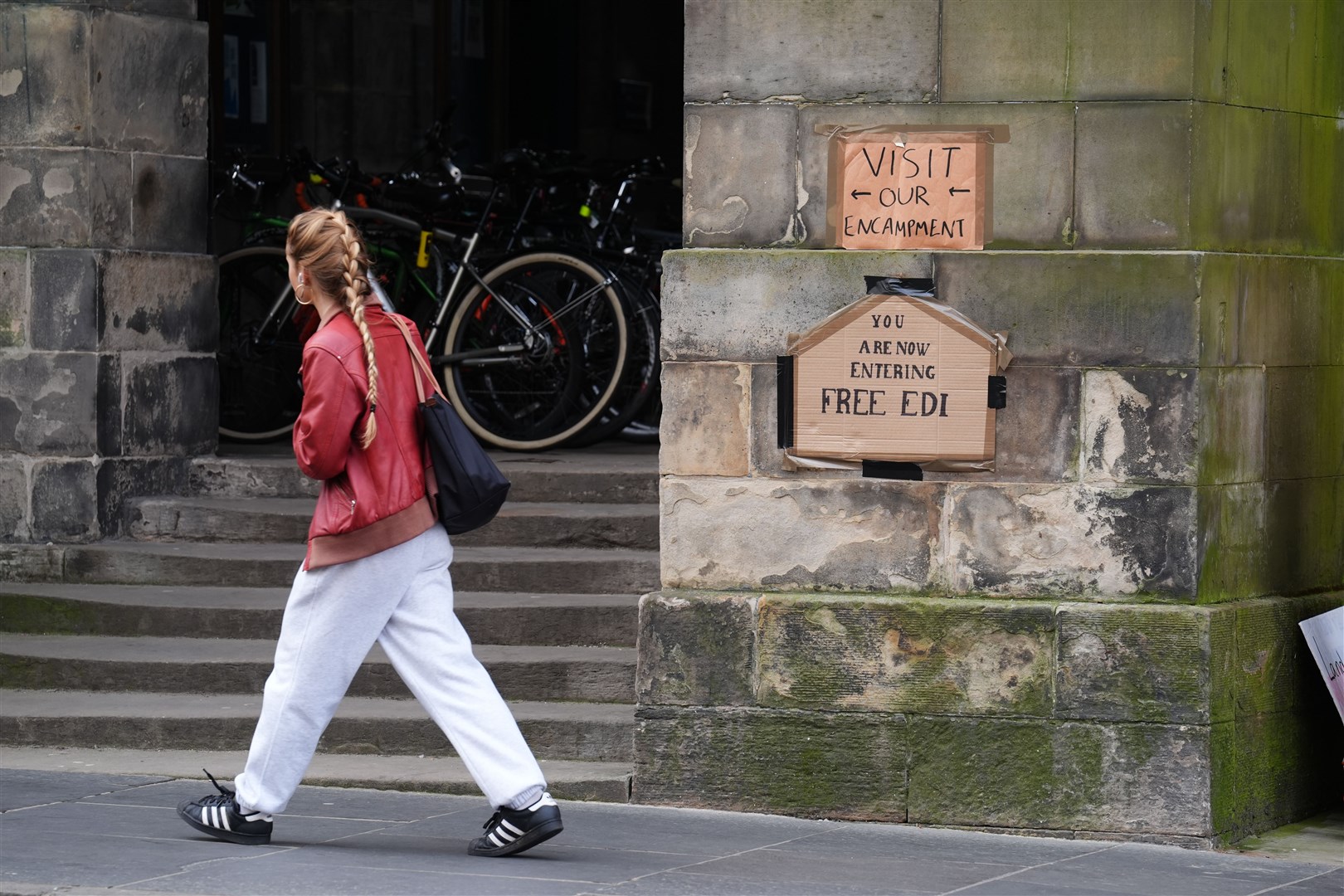Signs on show near students at an encampment at the Old College at the University of Edinburgh, protesting against the war in Gaza (Andrew Milligan/PA)