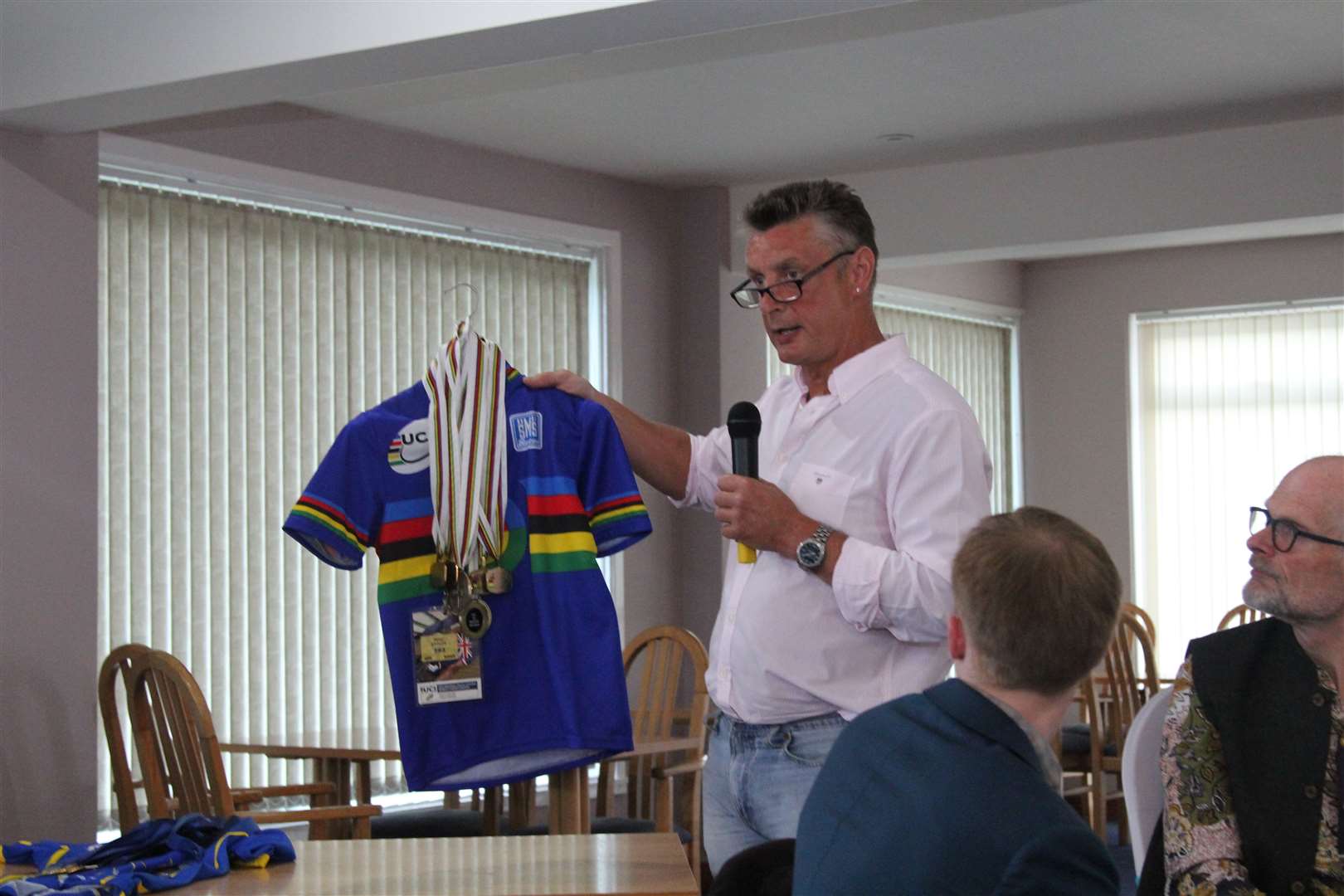 Peter Ettles shows interested members his shirts and medal collection.