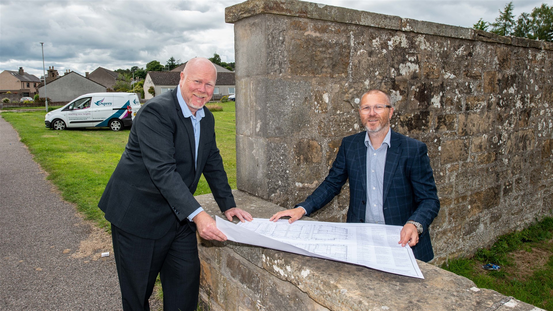 Allan Liddle (left), development officer at Osprey Housing Group, and John Main, managing director of Morlich Homes, looking over plans for the Elgin development on site.