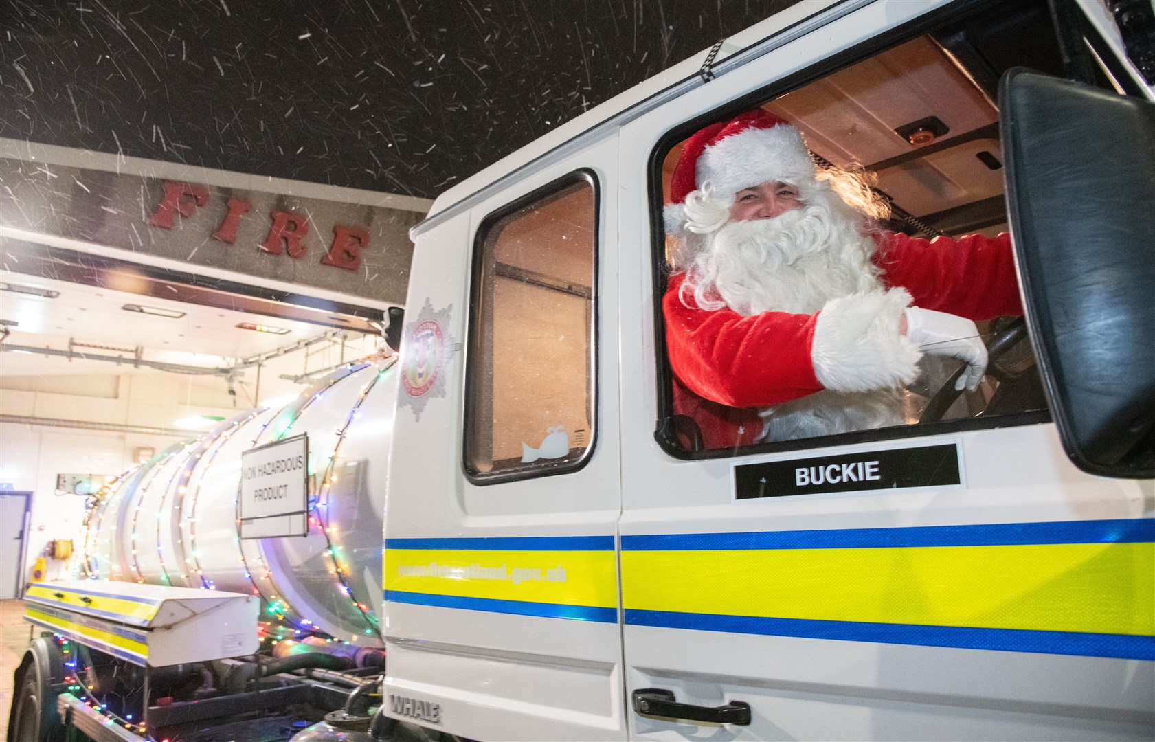 Santa swaps his sleigh for one of Buckie's fire engines. Picture: Daniel Forsyth