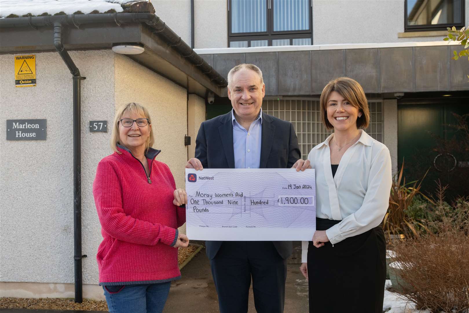Richard Lochhead MSP handing over a cheque to Moray Women's Aid manager Elle Johnston for £1900 with sponsor Diane Kemp (Springfield, Group HR Manager) with the generous sponsorship of his charity Christmas card by local businesses...Picture: Beth Taylor