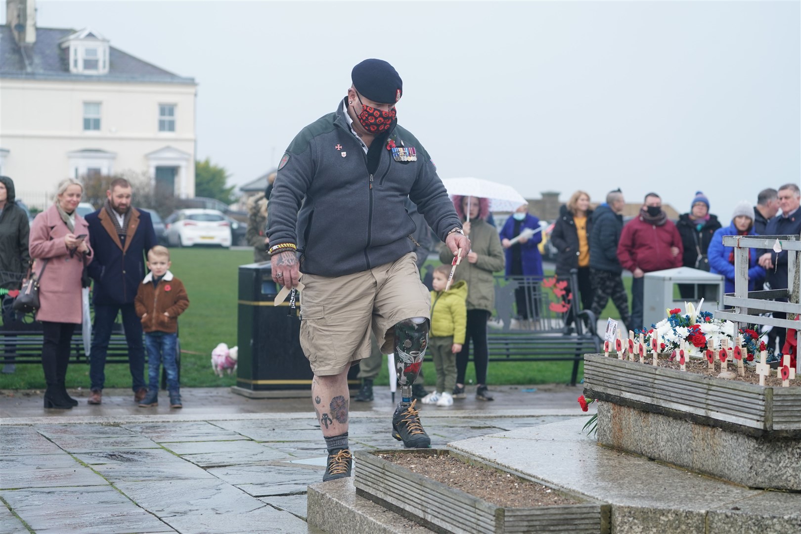 A veteran places a cross during the Seaham ceremony (Owen Humphreys/PA)