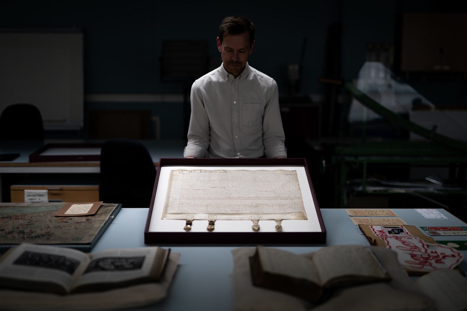 Laurence Ward, of the London Metropolitan Archives, holds a 1613 William Shakespeare property deed from Blackfriars (Aaron Chown/PA)