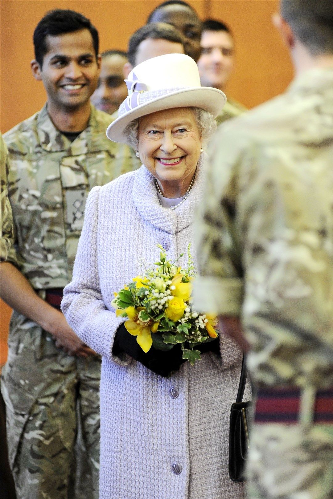 Queen Elizabeth is all smiles as she meets service personnel during a visit to Kinloss Barracks. Picture: Daniel Forsyth