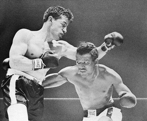 23 Apr 1952, Chicago, Illinois, USA --- Original caption: Champion Sugar Ray Robinson works over the midsection of challenger Rocky Graziano, at left, in the second round of a scheduled 15-rounder. Robinson knocked the rock in the third round. --- Image by © Bettmann/CORBIS