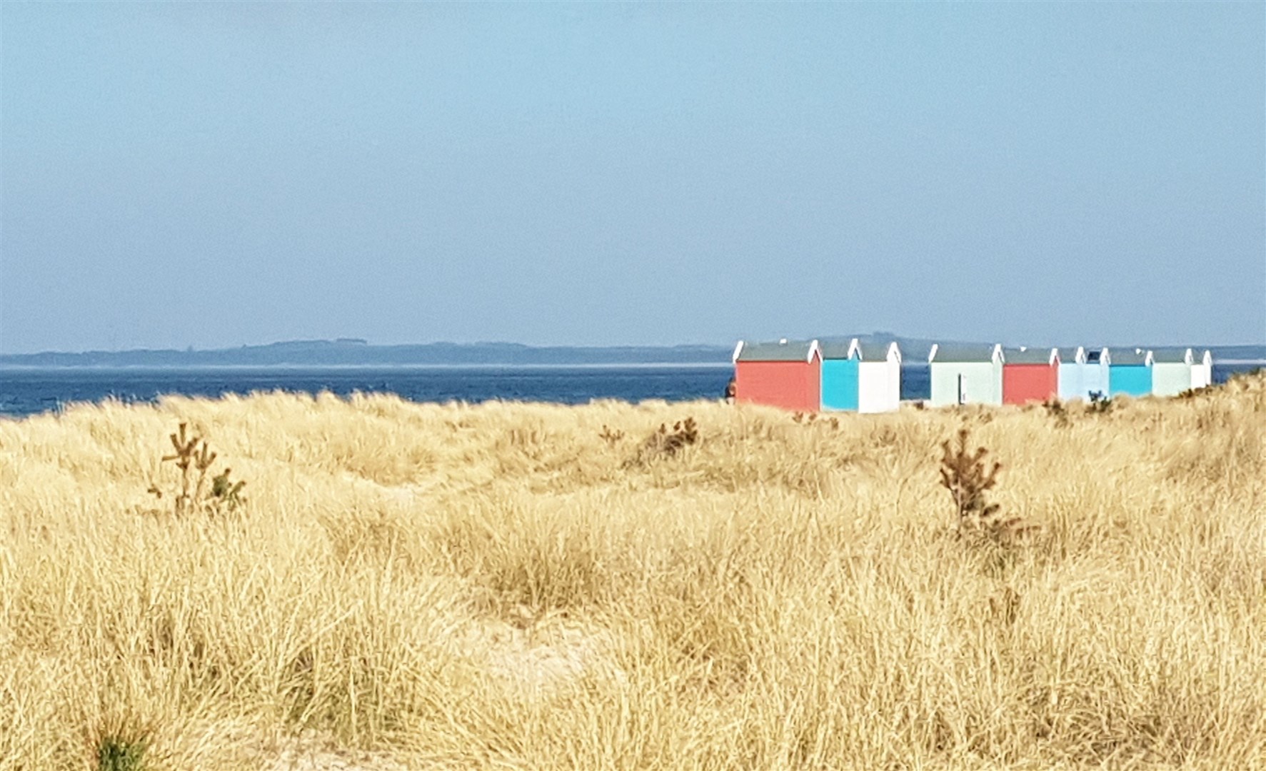 The colourful Findhorn Beach Huts.