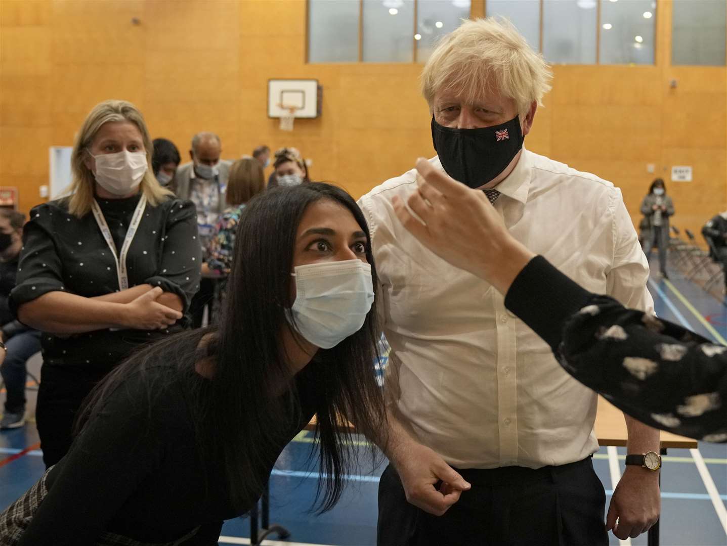 Prime Minister Boris Johnson watches as a dose of the Pfizer vaccine is diluted before being administered (Matt Dunham/PA)