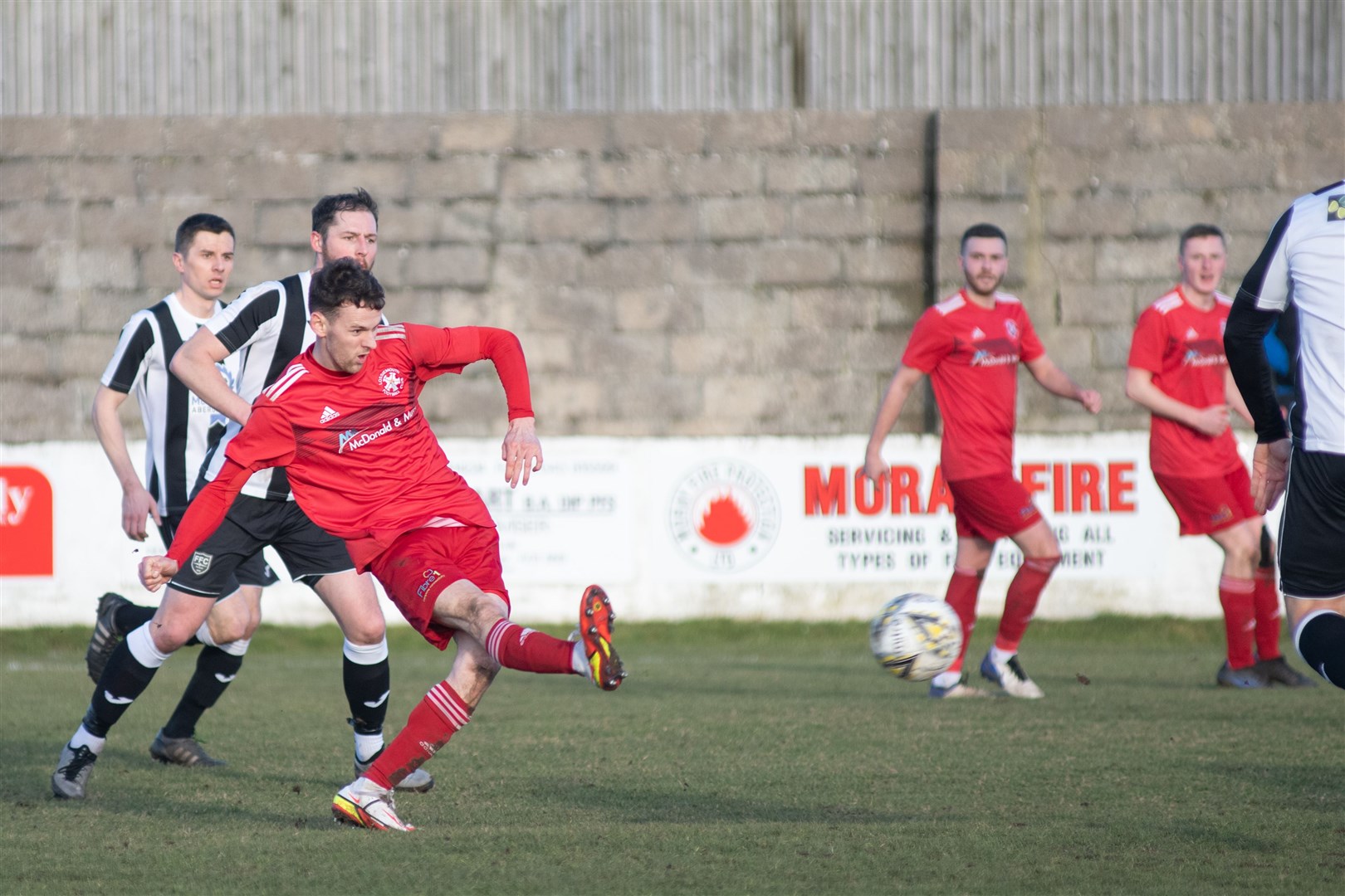 Ryan Farquhar takes a shot on goal for the home side during the first half...Lossiemouth FC vs Fraserburgh FC - Highland League Football - Grant Park, Lossiemouth 19/02/2022...Picture: Daniel Forsyth..