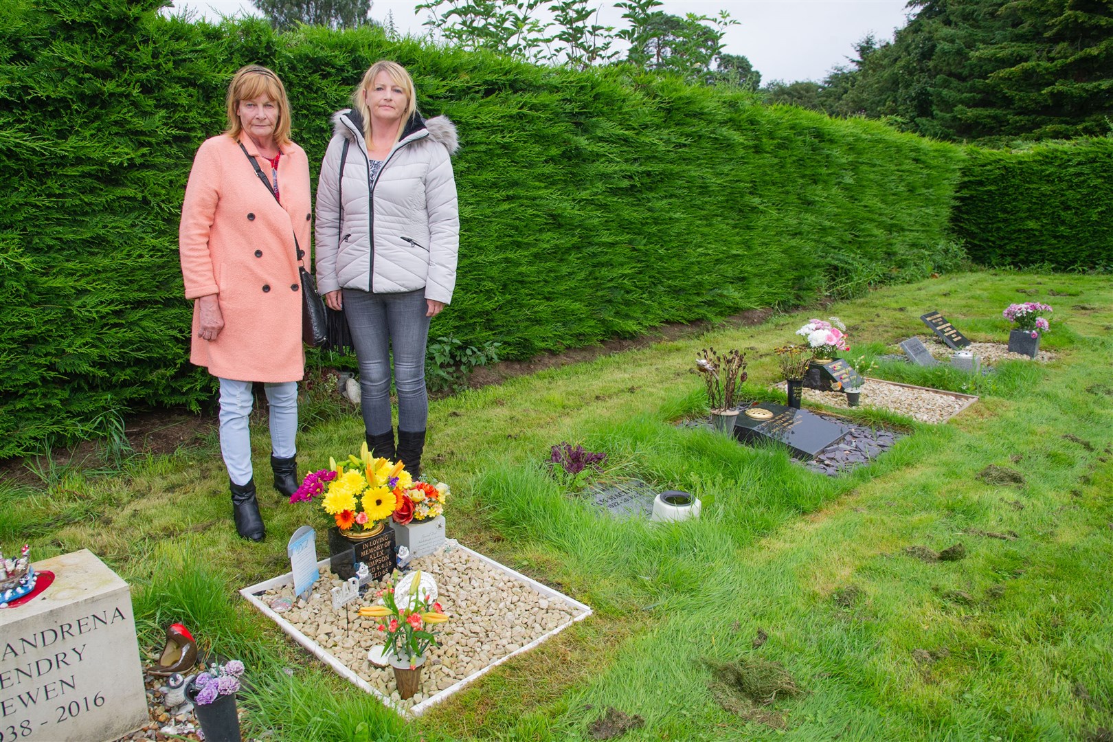 Mother and daughter Brenda Harnden (Left) and Julie Simpson (Right), who have family graves at Lhanbryde Cemetary - are unhappy with the state of the cemetary..The grass has been roughly cut and left and the ground is being dug up by moles...Picture: Daniel Forsyth. Image No.044620.