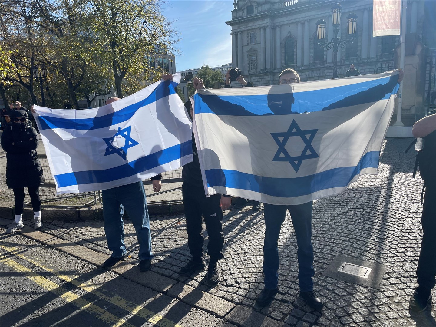 A small group carrying Israeli flags met the rally as it neared Belfast City Hall (Jonathan McCambridge/PA)