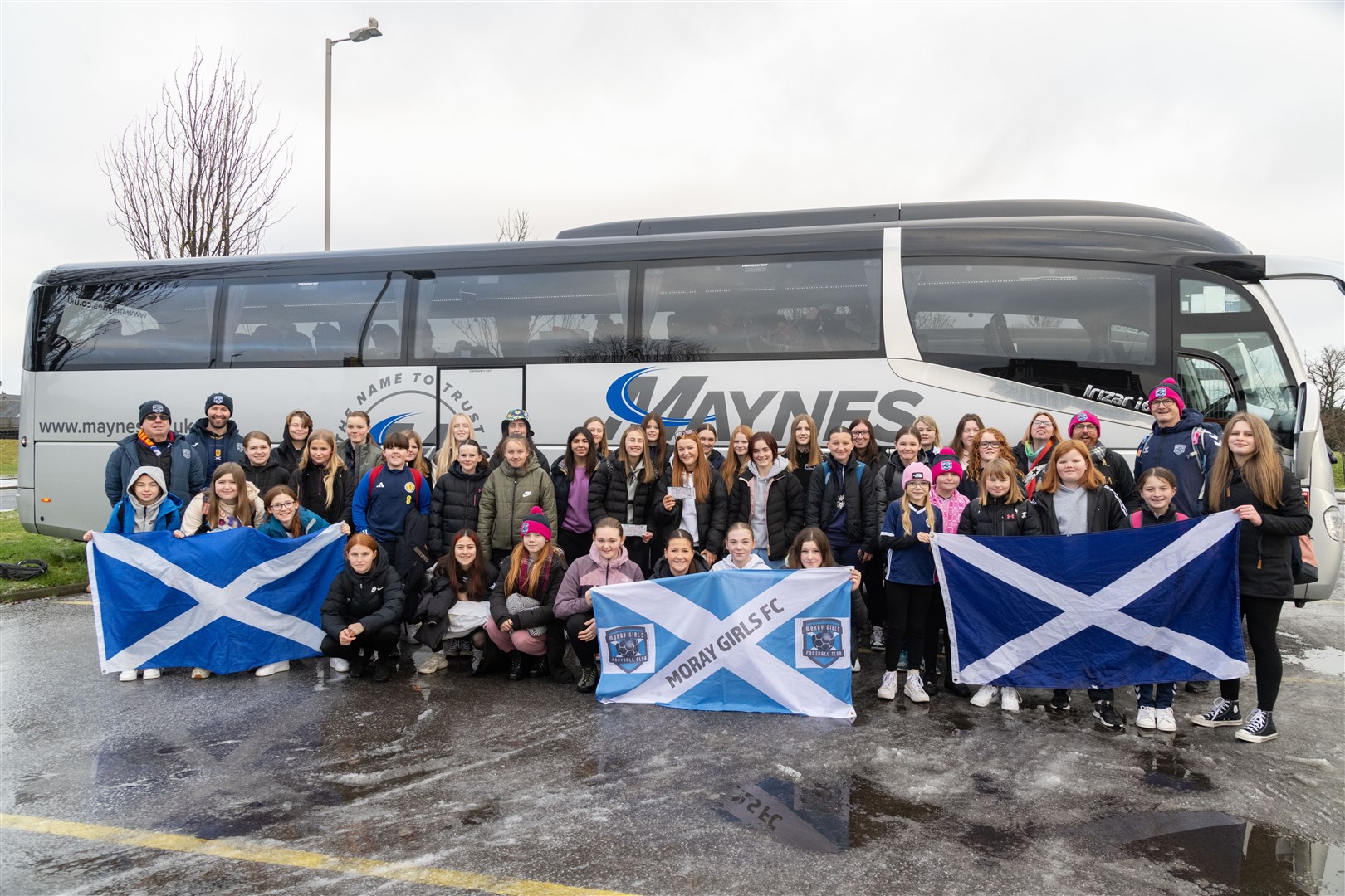 Moray Girls Football team waving flags before leaving for the Scotland v England game at Hampden Stadium after celebrating another successful season. ..Picture: Beth Taylor.