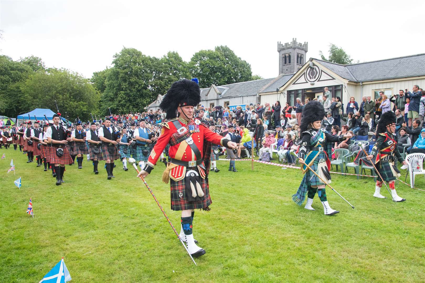 The Massed Pipe Band make their way around the games arena...77th Aberlour Strathspey Highland Games held on Saturday 6th August 2022...Picture: Daniel Forsyth..
