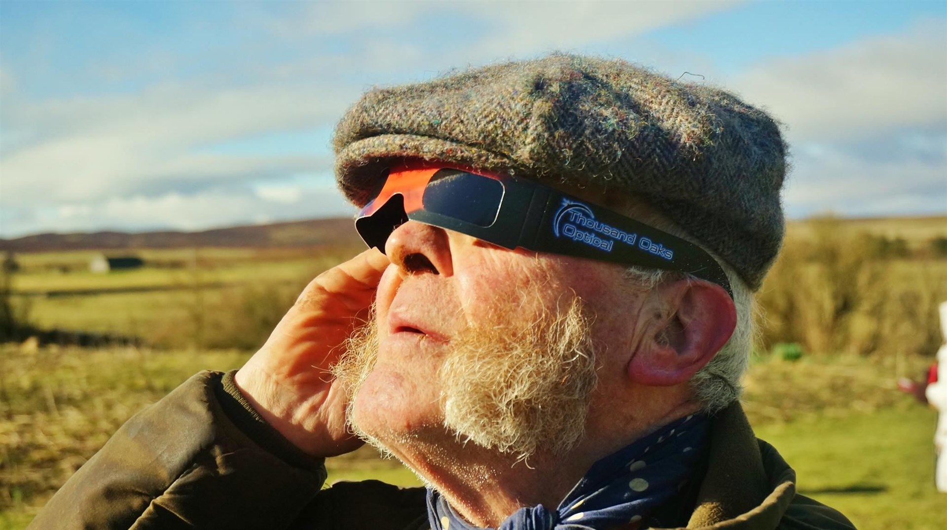 There was a partial eclipse of the sun visible from sites in Caithness back in 2015. Guy Wallace is pictured at Thrumster viewing the spectacle through special solar glasses. Picture: DGS