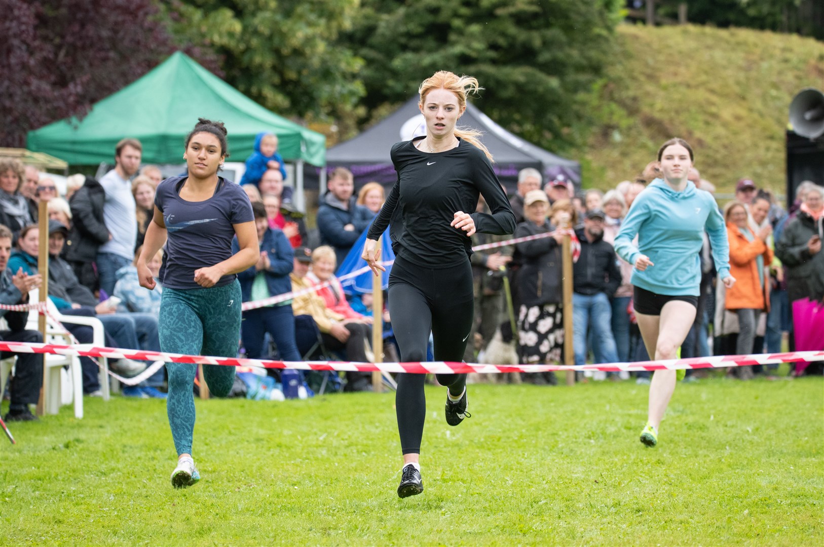 Finish of the 200 metre ladies race (from left) 2nd place Tamsin Fowlie, 1st Lauren Abbott and 3rd Ava Cruickshank. Picture: Daniel Forsyth