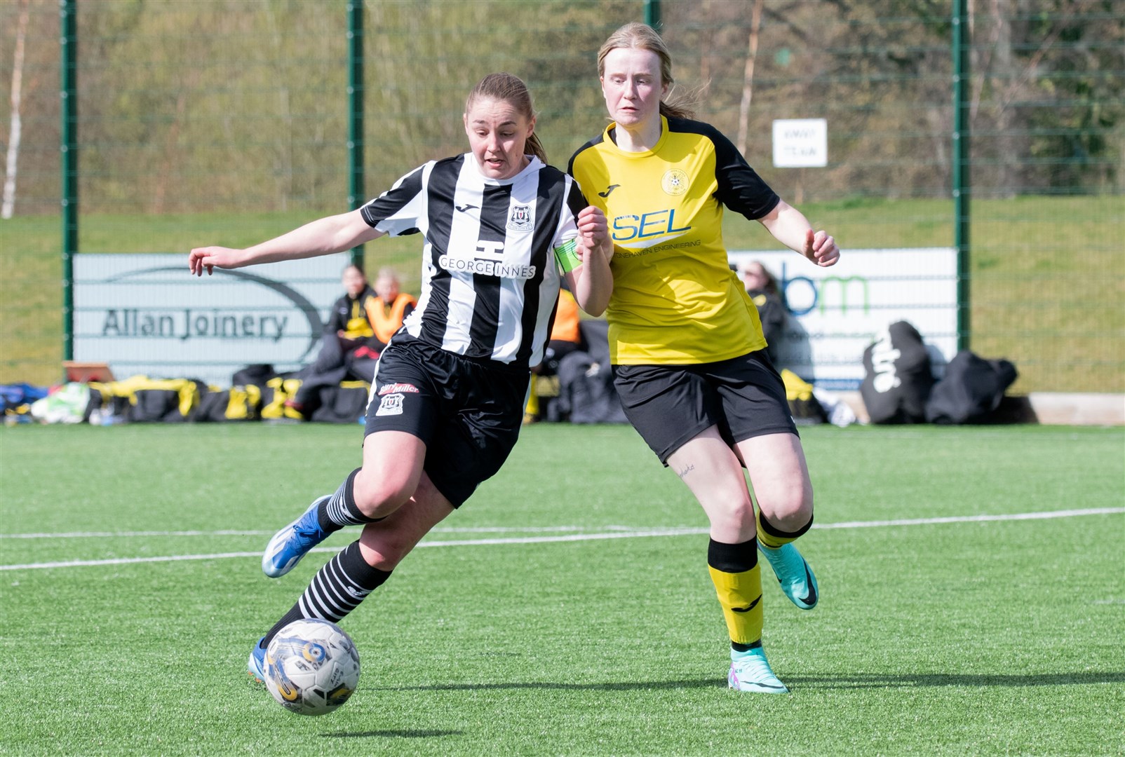 Elgin City's Abigail Hayes holds off a challenging Brodie Crighton of Stonehaven.Picture: Daniel Forsyth.