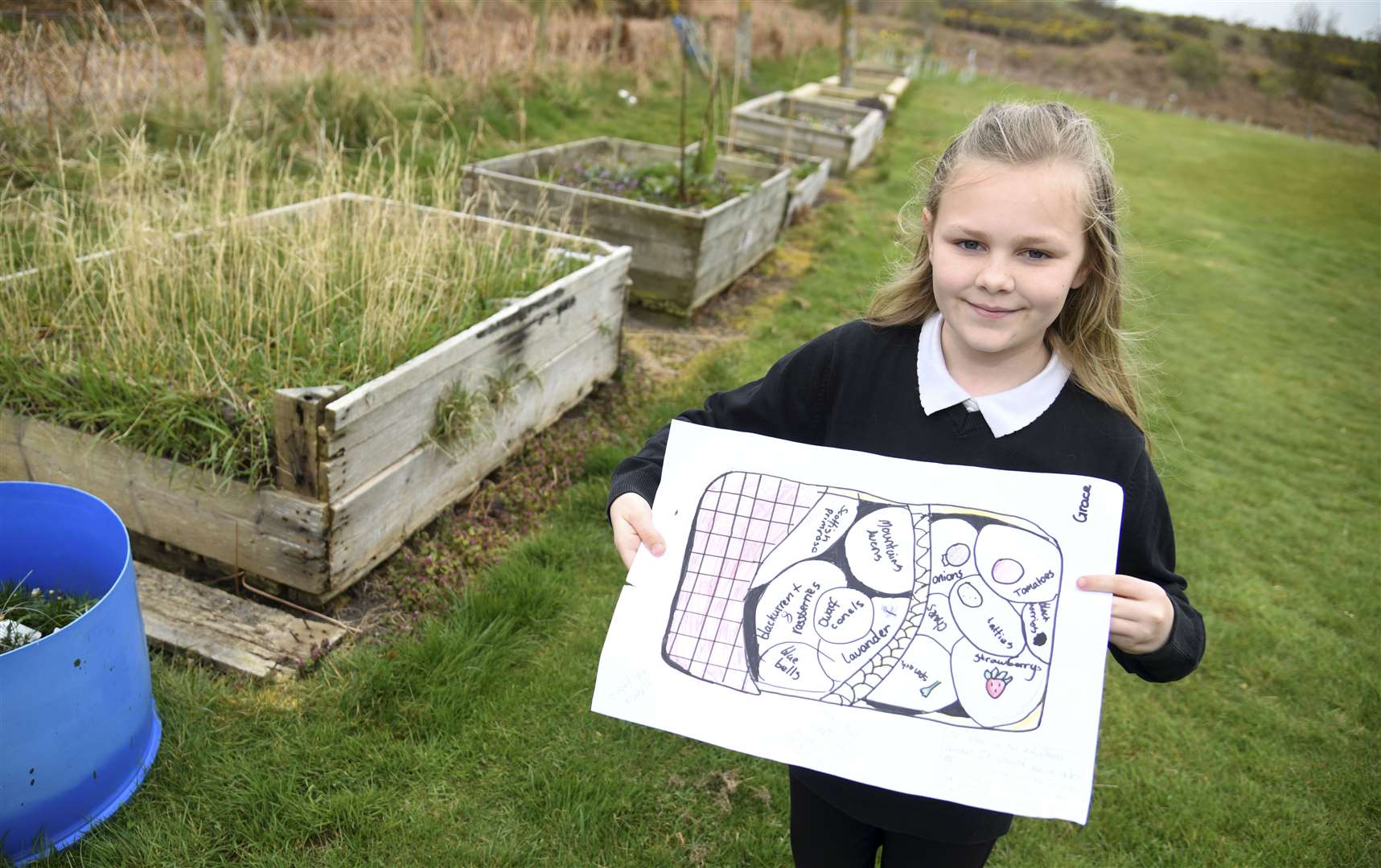 Going to plan...Findochty Primary's Grace Slater proudly shows off her winning design which will be brought to life in the school's garden. Picture: Becky Saunderson