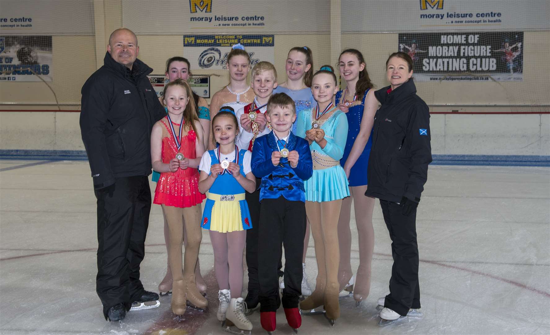 Moray Figure Skating Club’s London competitors show their medals to coaches Graeme Summers and Sue Summers-Farrell.