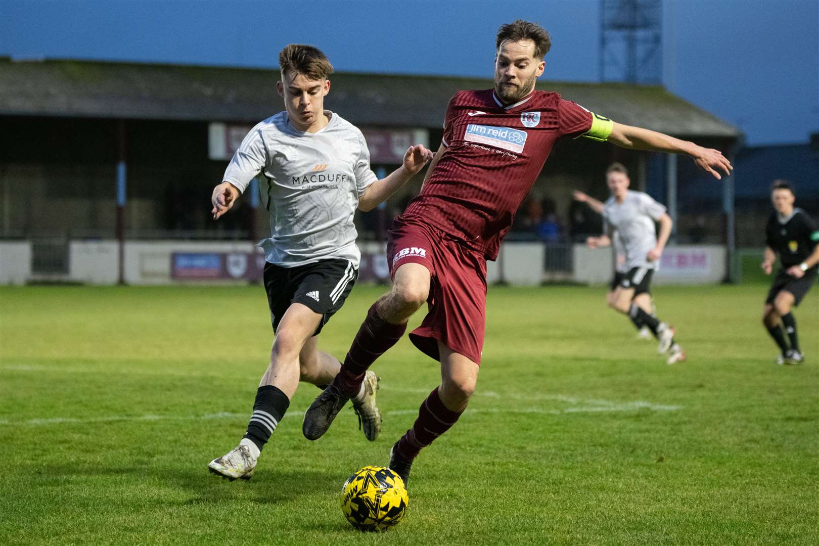 Keith skipper James Brownie competes against Deveronvale's Michael Watson for the ball. ..Keith FC (3) vs Deveronvale FC (2) - Highland Football League 23/24 - Kynoch Park, Keith 09/12/2023...Picture: Daniel Forsyth..