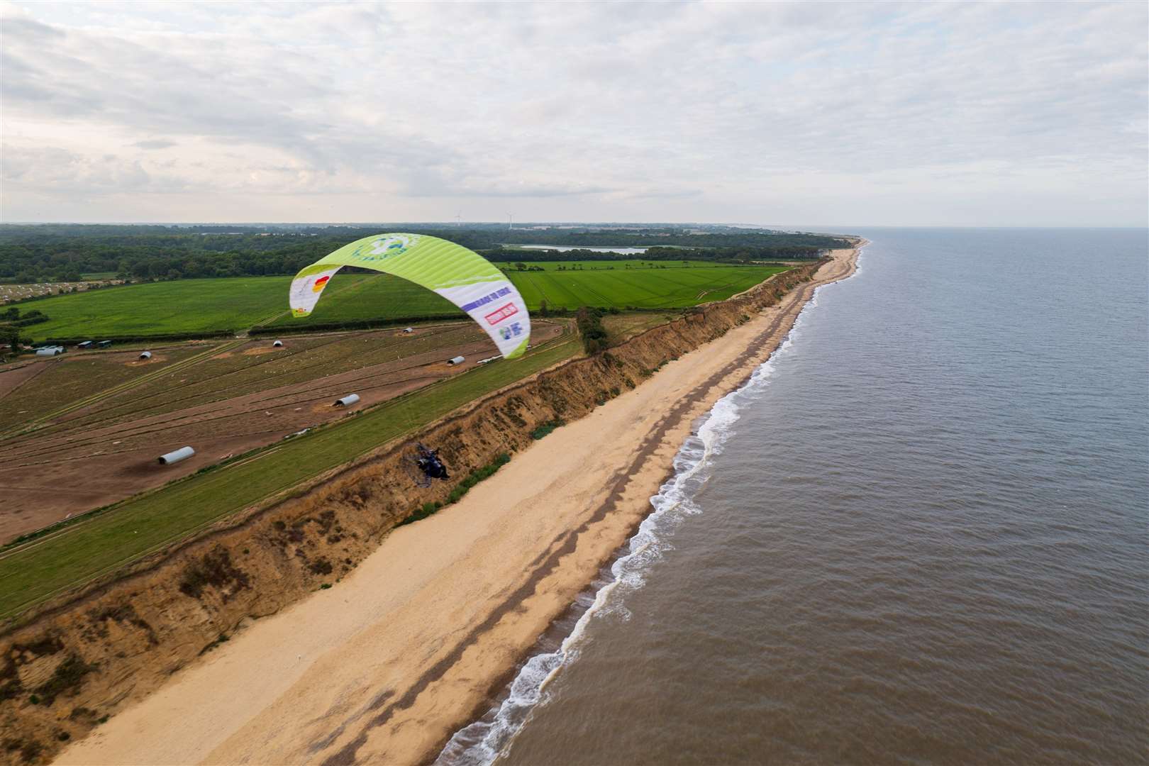 Sacha Dench is attempting a 3,000-plus mile circumnavigation of Britain flying a green-powered paramotor.