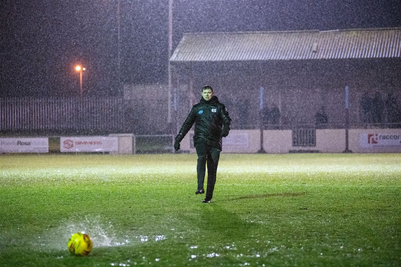 Buckie's manager Graeme Stewart tries out the pitch after doubt is cast over the tie due to the heavy rain. Picture: Daniel Forsyth..