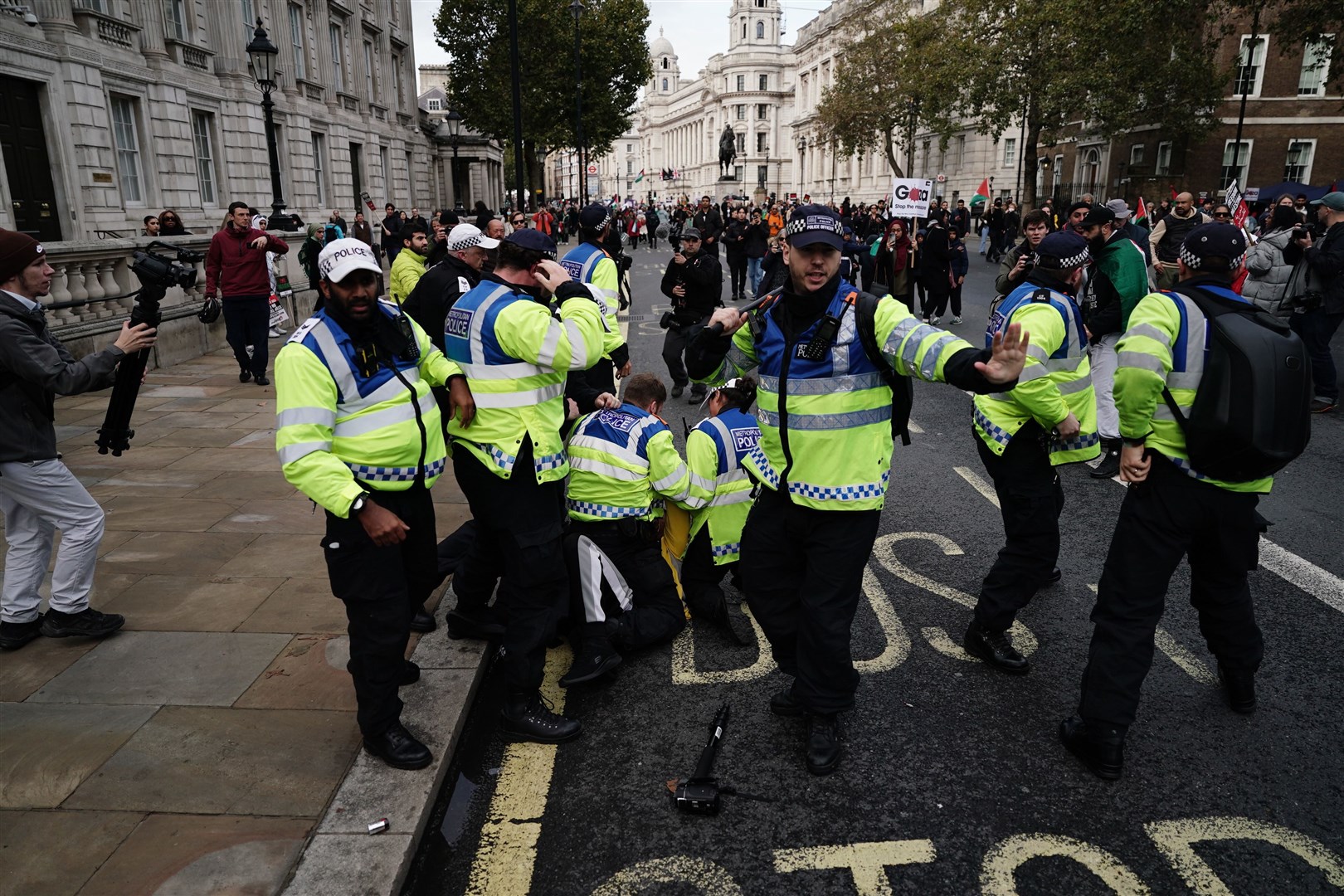 Police detain a man following scuffles between rival supporters near the Cenotaph in Whitehall during a pro-Palestine march (Jordan Pettitt PA)