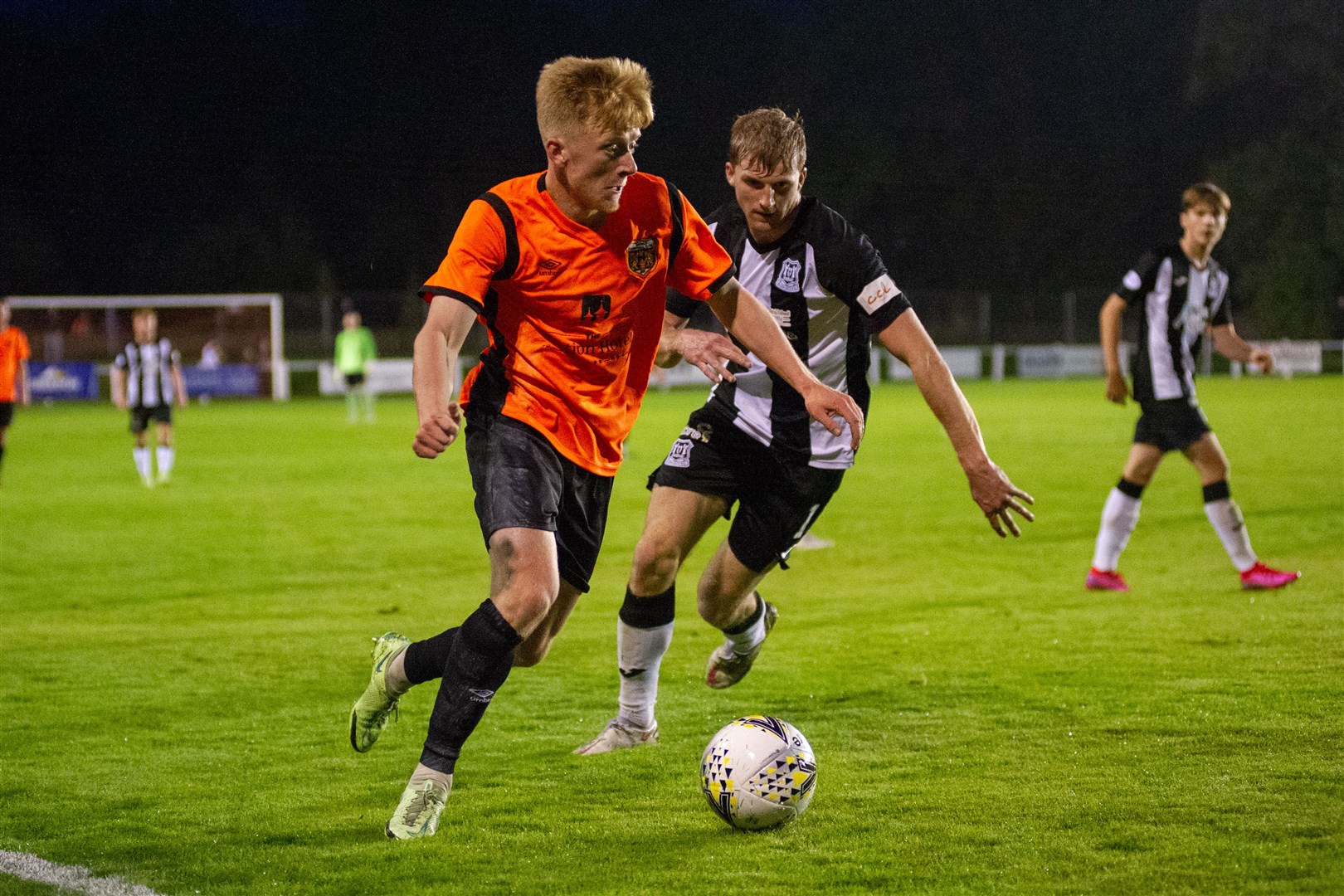 Rothes' Ross Gunn and Elgin's Aidan Sopel compete. ..Rothes FC (2) vs Elgin City FC (0) - North of Scotland Cup Quarter Final - Mackessack Park, Rothes 18/08/2021...Picture: Daniel Forsyth....