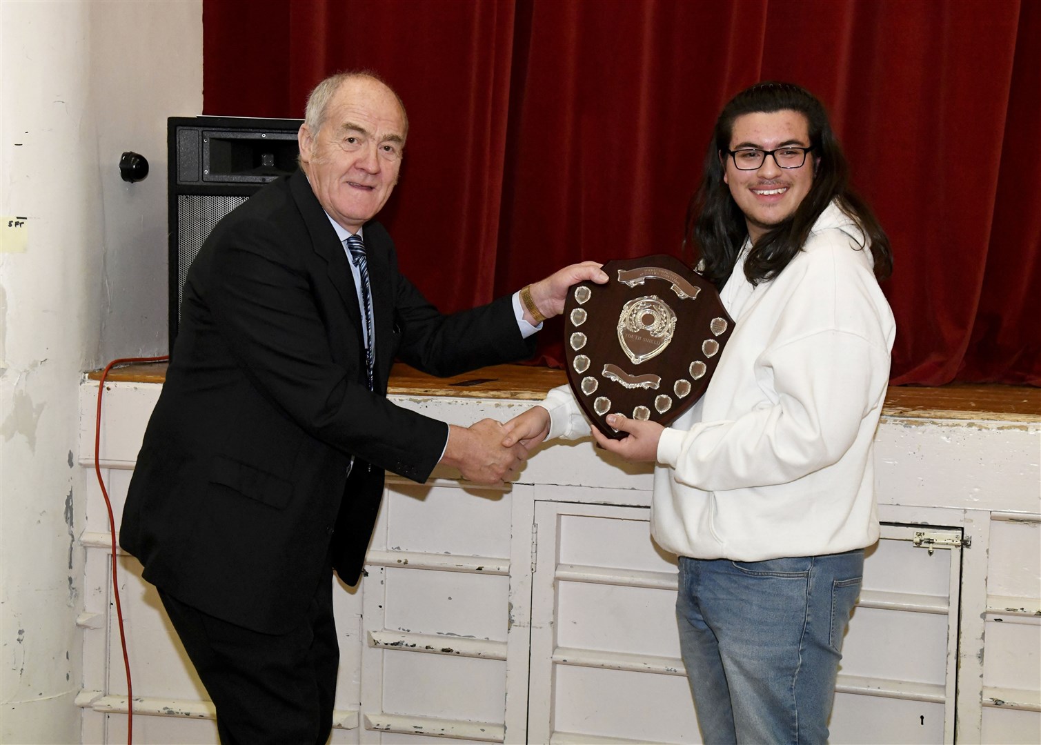 George Alexander awarding Ben Stewart with the Forres Community Activities Association Youth Shield last year.