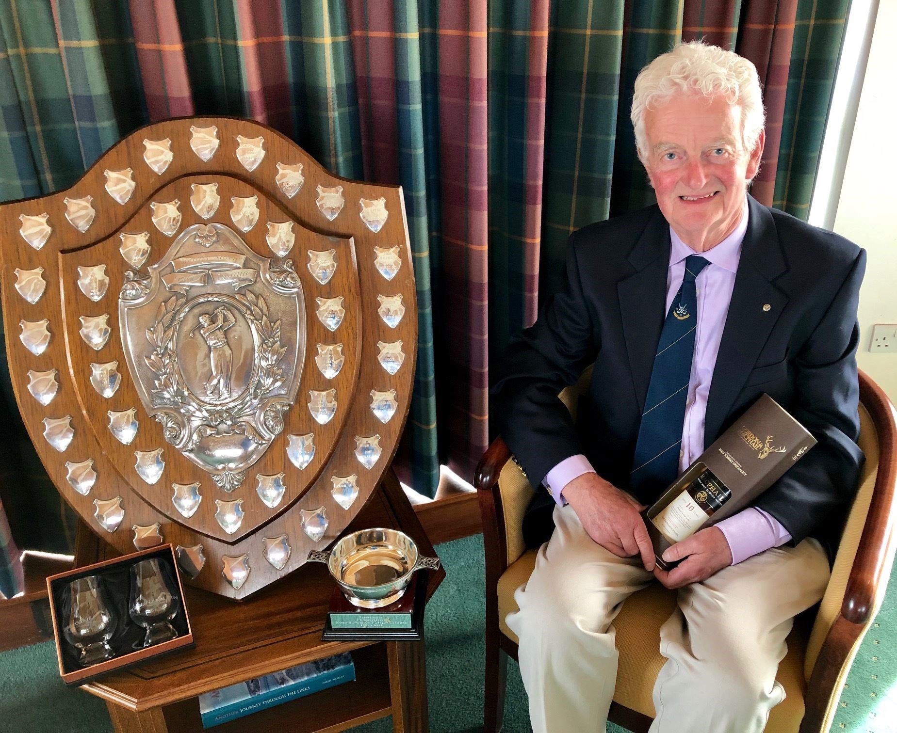 James Macpherson with gifts from the Moray and Nairn Golf League after he stepped down as chairman after 17 years.