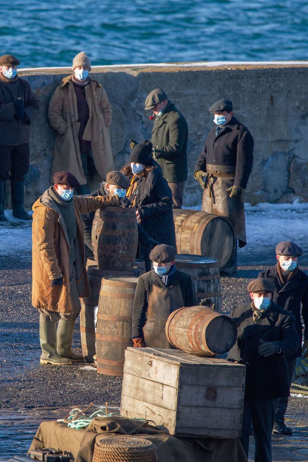 The 1930s mixed with 2021 as extras wear Covid protective masks during filming of Peaky Blinders in Portsoy. Picture: Daniel Forsyth