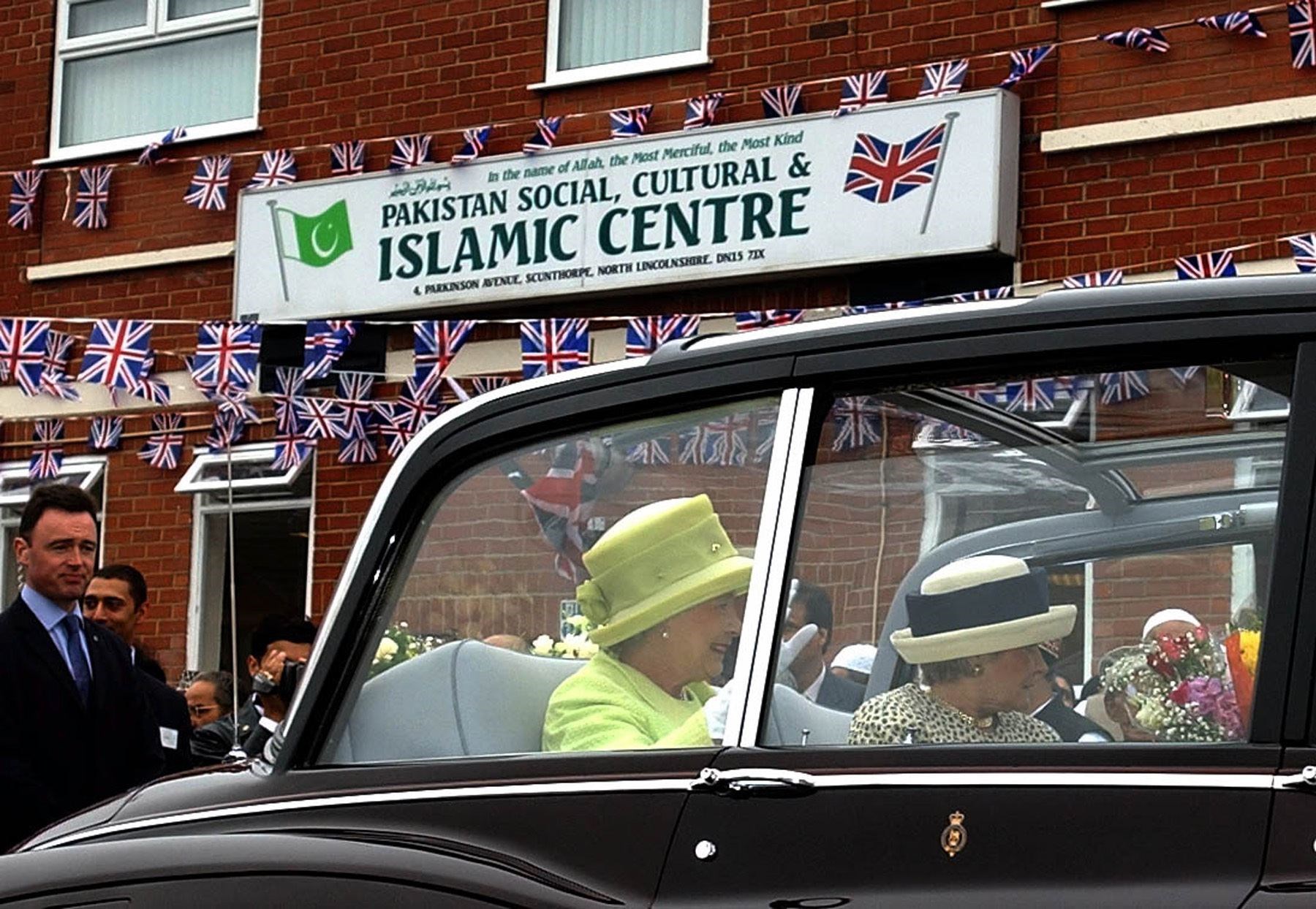 The Queen waves to the crowds after receiving gifts during her visit to a mosque in Scunthorpe, north Lincolnshire (John Giles/PA)