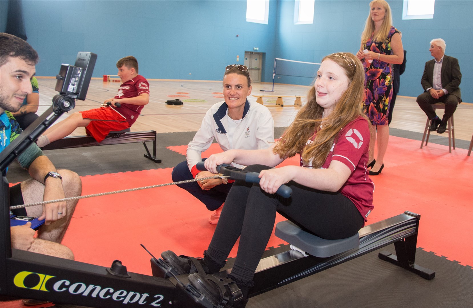 Millie Anderson, of Mosstowie Primary, takes on the rowing challenge as Heather Stanning looks on. Picture: Becky Saunderson. Image No.044669.