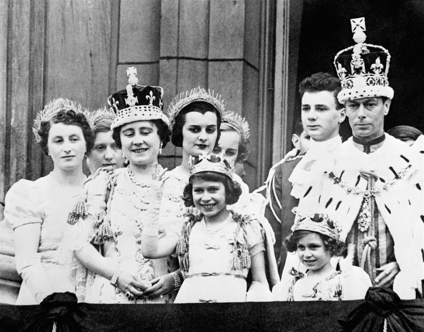 Queen Elizabeth (later the Queen Mother), Princess Elizabeth (centre) and King George VI after his coronation (PA)