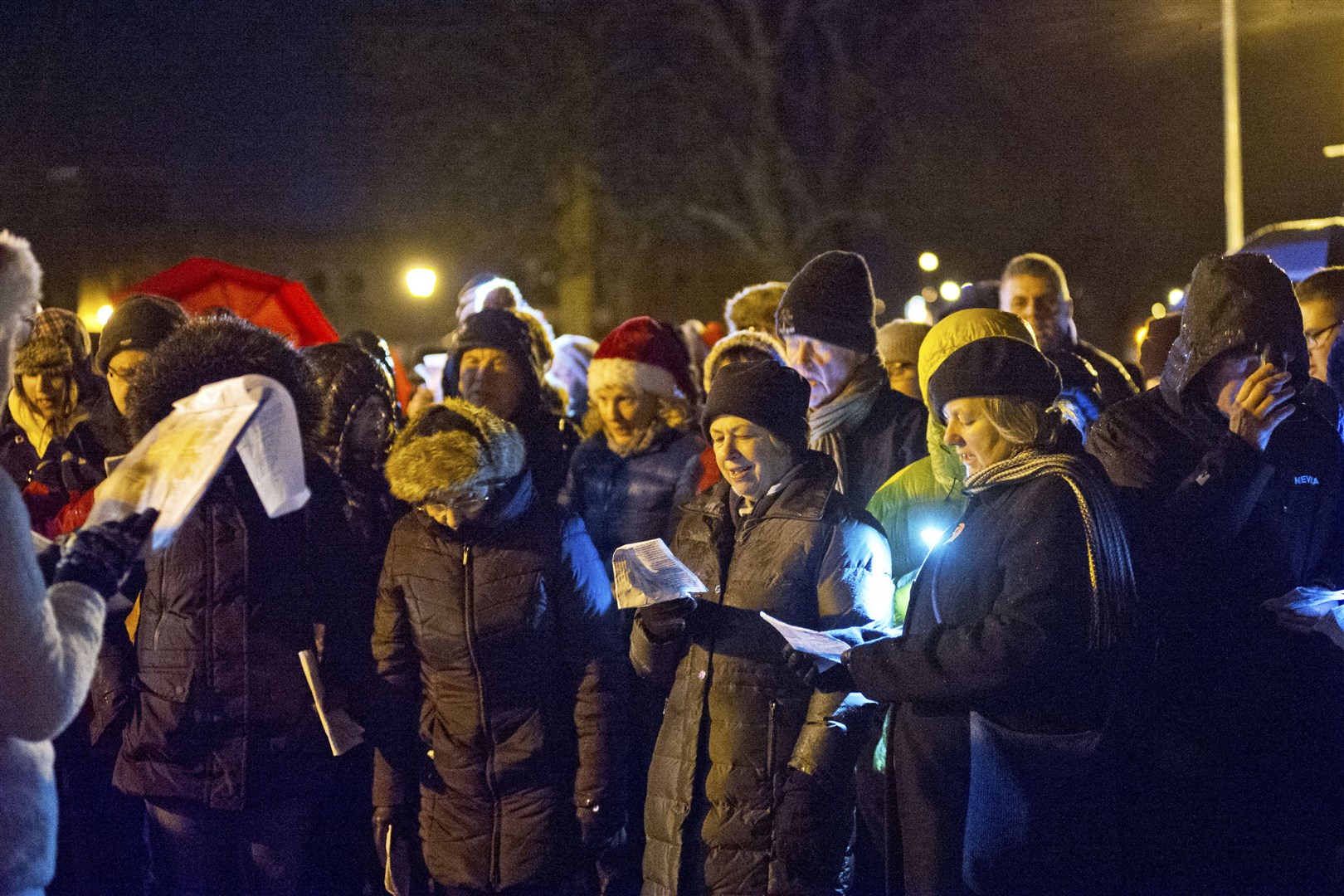 Crowds gather to enjoy Carols at Cooper Park by Moray Concert Brass.