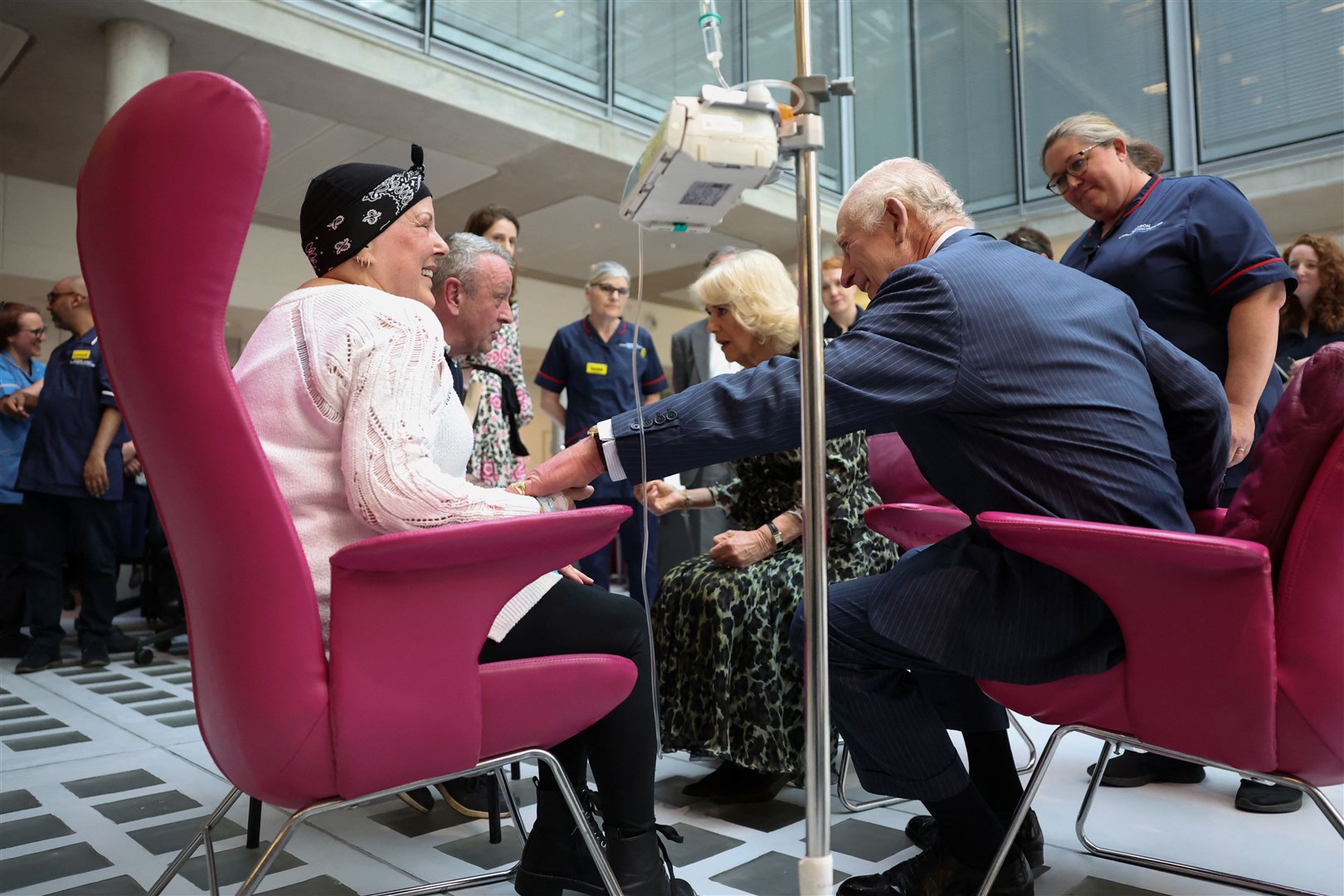 The King and Queen meet cancer patient Lesley Woodbridge undergoing chemotherapy in the day unit and her husband Roger (Suzanne Plunkett/PA)