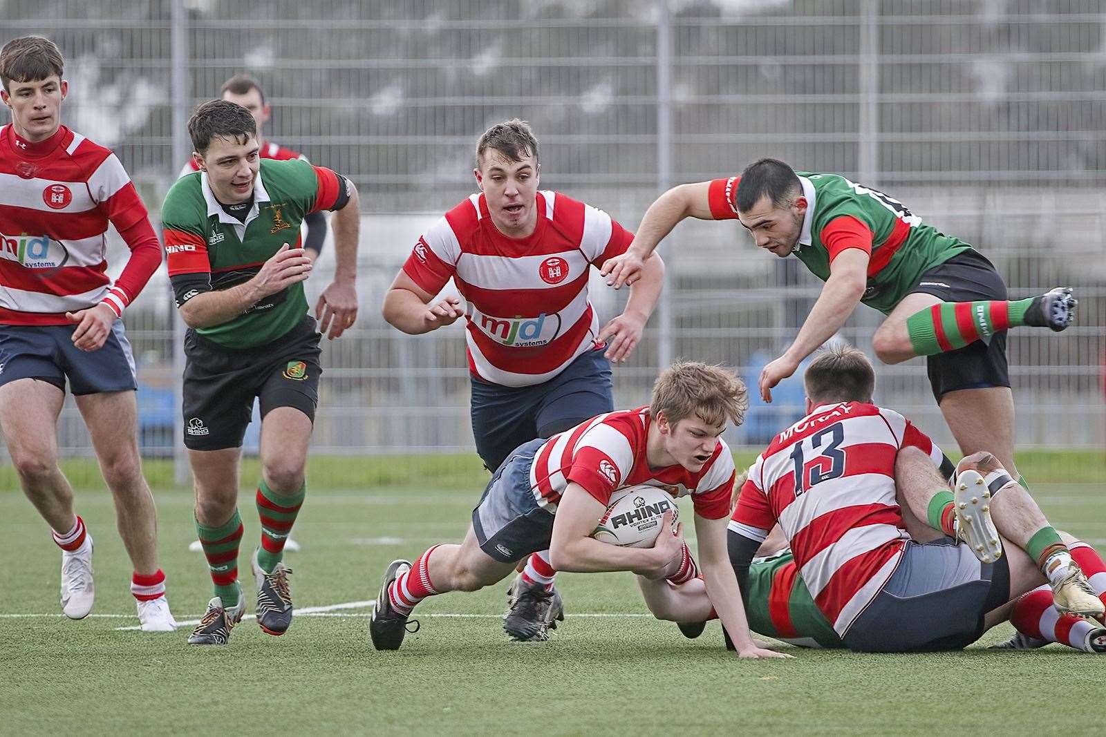 Tom Letch with the ball for Moray accompanied by team-mates Rory Millar and Cameron Hughes. Photo: John Macgregor