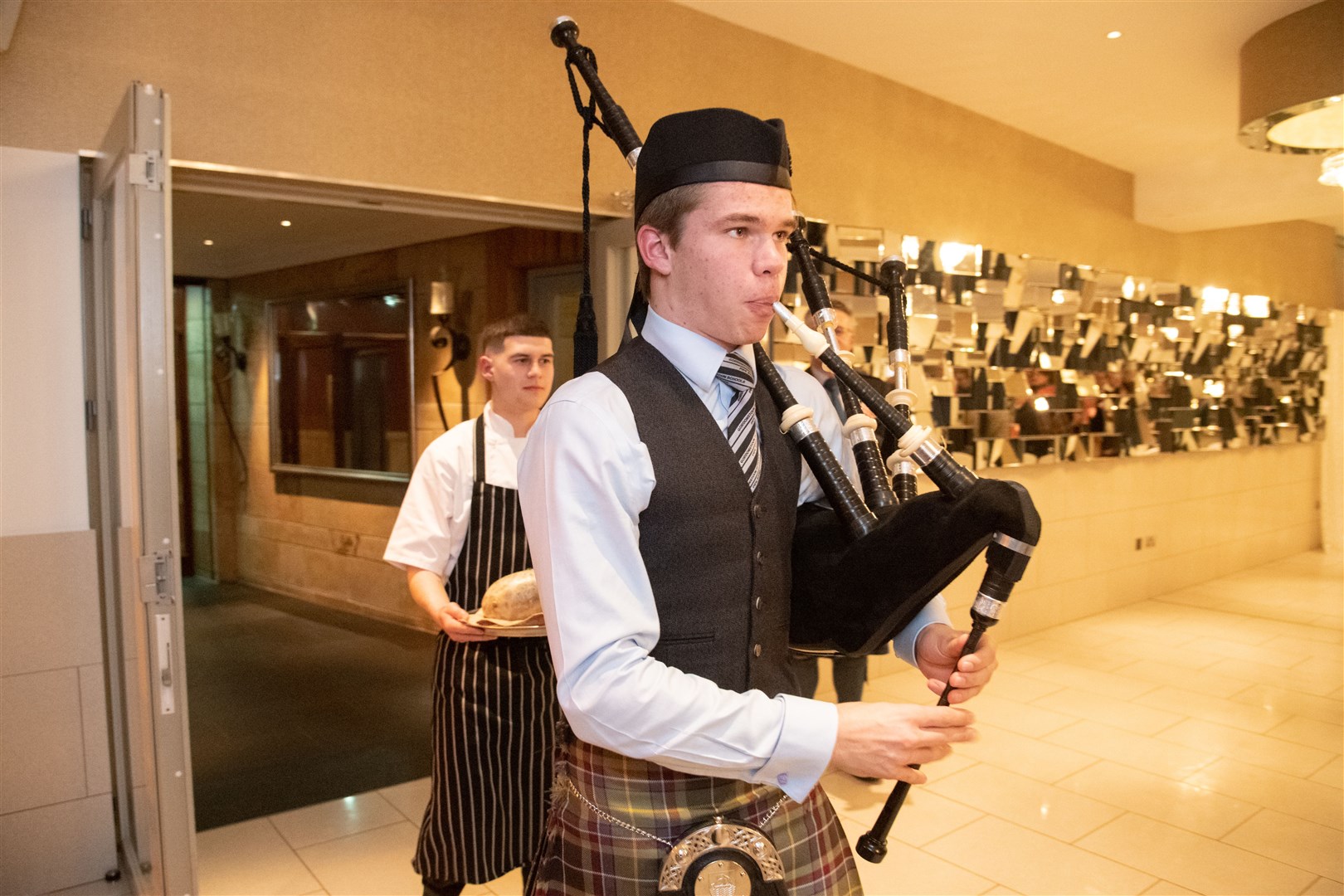 The haggis, carried by Marcus Milton, is piped in by Gordonstoun Piper Hamish Martindale. ..Elgin Burns Club's annual anniversary dinner at the Mansefield Hotel. ..Picture: Daniel Forsyth..