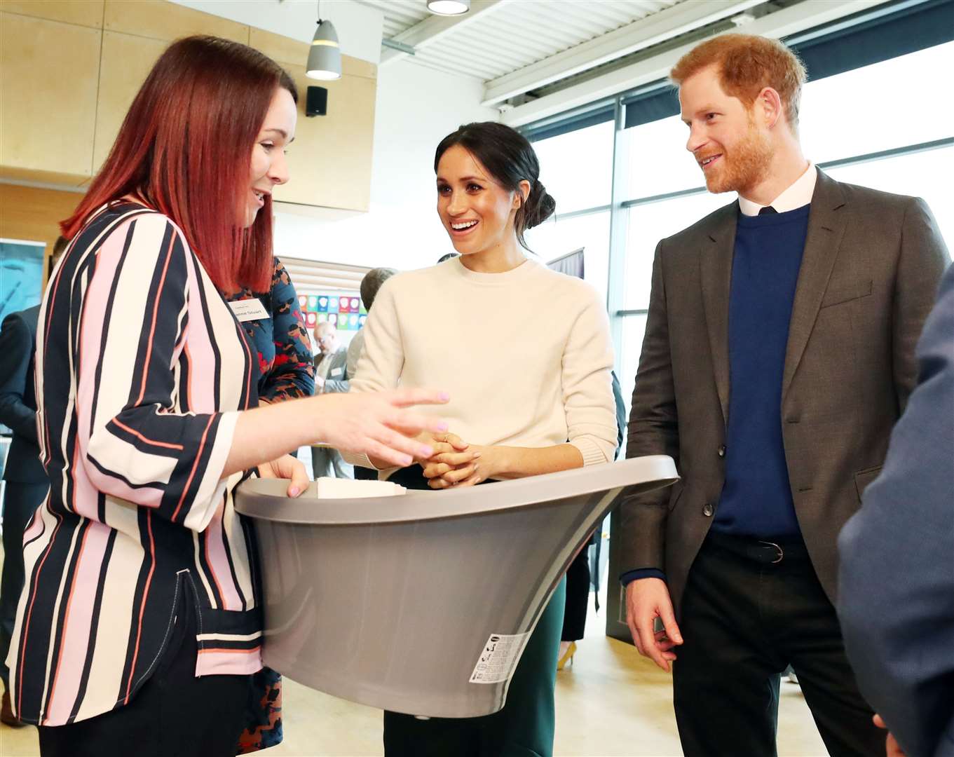 Harry and Meghan look at a baby bath during a visit to Belfast (Niall Carson/PA)