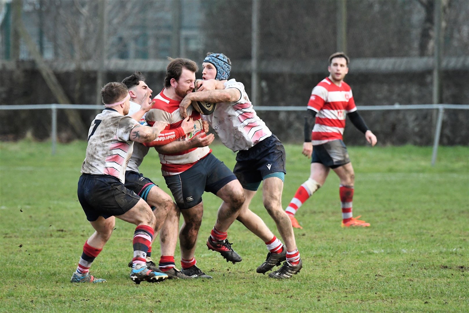 Mark Taylor is tackled by three Aberdeen Grammar defenders. Photo: James Officer