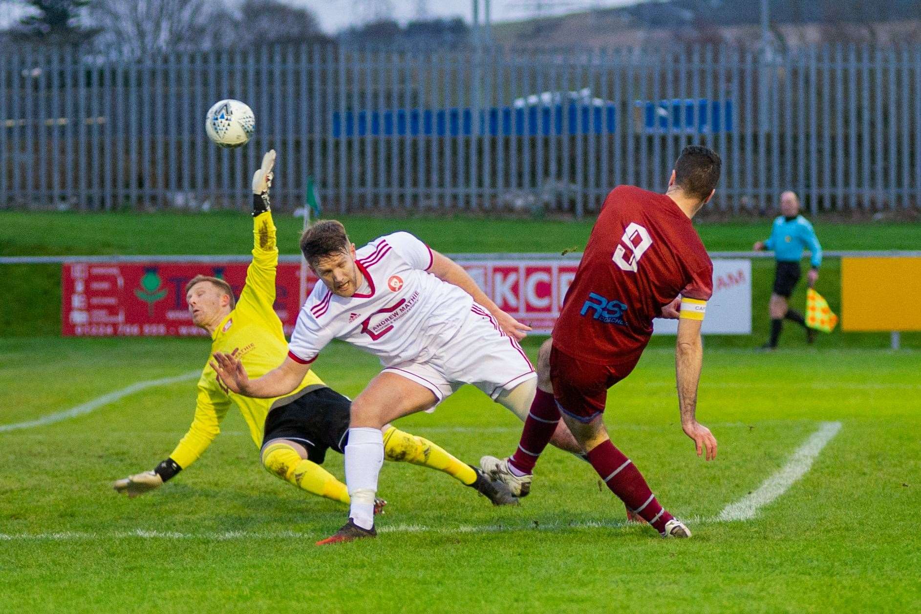 Keith forward Cammy Keith opens the scoring past Beath defender Kevin Connors and goalkeeper Stuart Hall...Keith FC (2) vs Hill of Beath Hawthorn FC (2) - Keith FC win 4-2 after extra time - Scottish Cup First Round - Kynoch Park, 26/12/2020...Picture: Daniel Forsyth..
