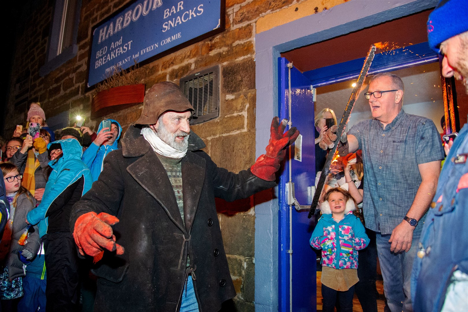 Grant Cormie of the Harbour Inn receives his burning stave from Clavie King Dan Ralph. ..The village of Burghead welcome in the 2020 New Year on the 11th of January with their traditional Burning of the Clavie Celebration...Picture: Daniel Forsyth..