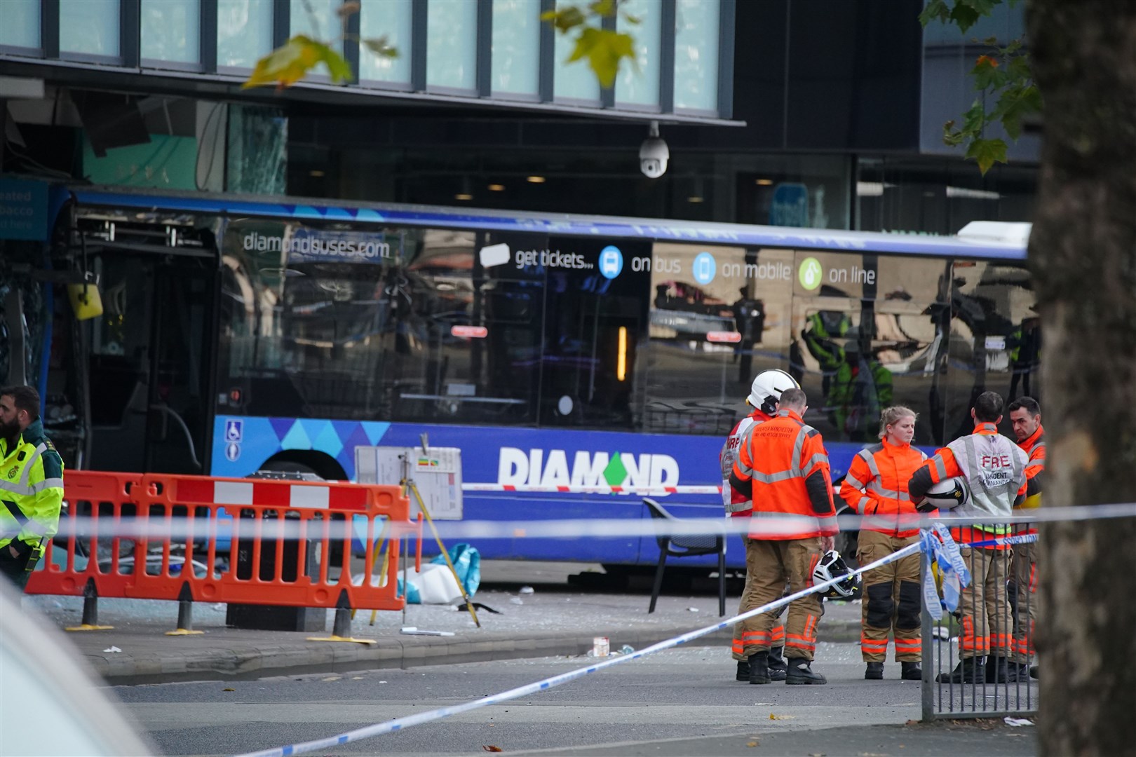 Emergency services at the scene of a bus crash at the City Tower building in Manchester (Peter Byrne/PA)