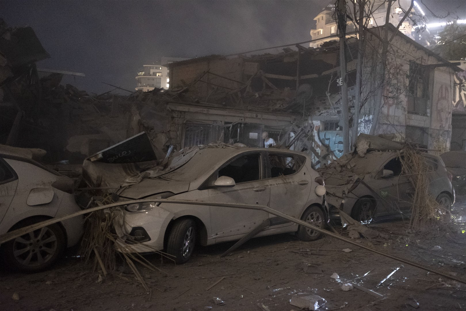 Cars and a building are seen after a rocket fired from the Gaza Strip into Tel Aviv (Moti Milrod/AP)