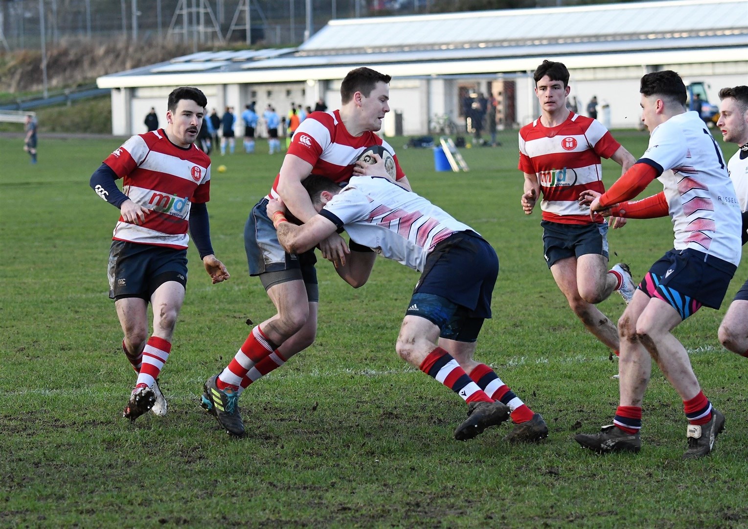 Arran Ruck runs into strong tackle with Calum Archibald and Rory Millar in support. Photo: James Officer