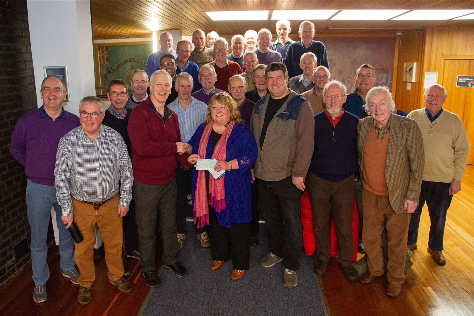 Members of Glen Moray Male Voice Choir hand over a cheque for £2000 to Liz Robson of Epilepsy Research UK, raised during their Winter Concert. Picture: Daniel Forsyth.