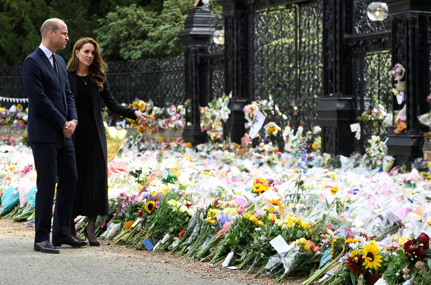 The Prince and Princess of Wales look at flowers left in memory of the Queen at Sandringham (Toby Melville/PA)