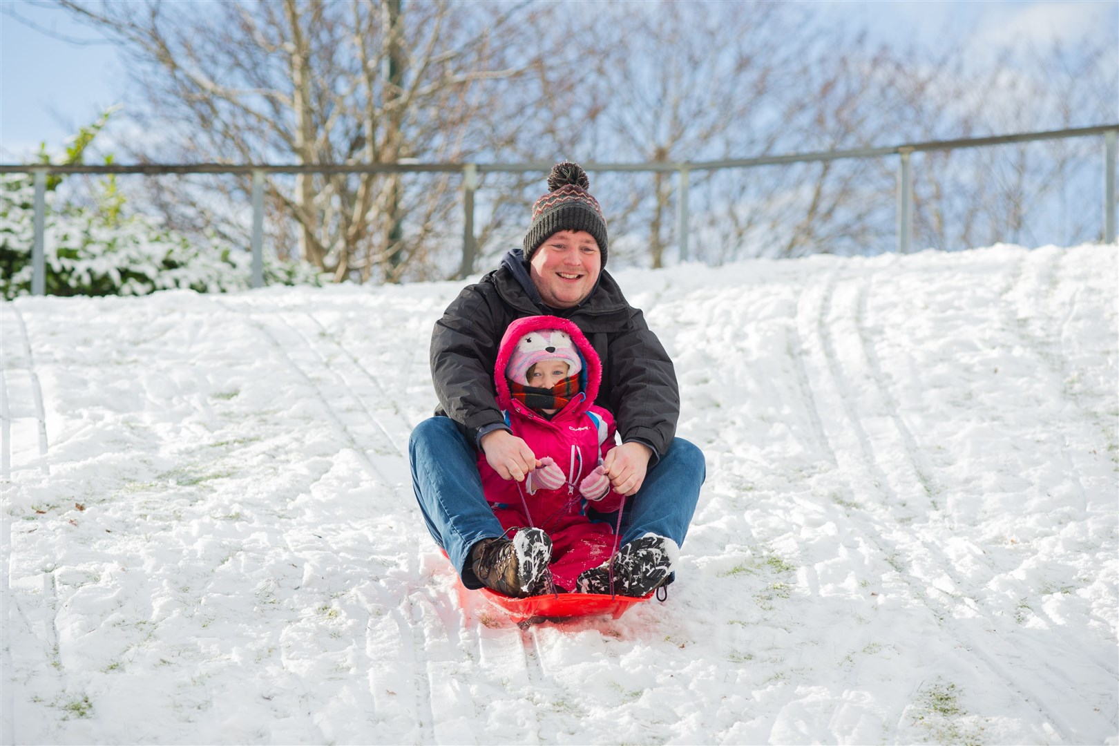 Arya Dean with father James sledging at Cooper Park...Picture: Daniel Forsyth..
